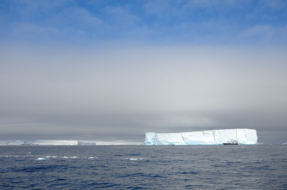 The M/Y Hanse Explorer dwarfed by tabular icebergs in Antarctic Sound. * Photo: Richard White