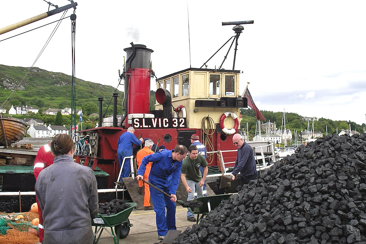 Shoveling coal onto the adorable VIC 32. * Photo: Puffer Steamboat Holidays