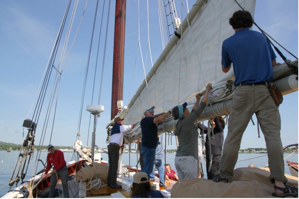 passengers helping with the sails