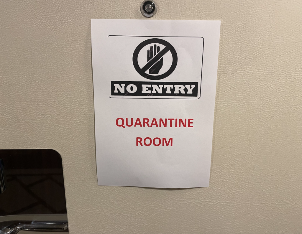 COVID quarantine sign on door of World Navigator