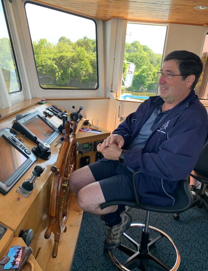 Captain Marc at the helm of Kawartha Voyageur cruising Canada's Rideau Canal