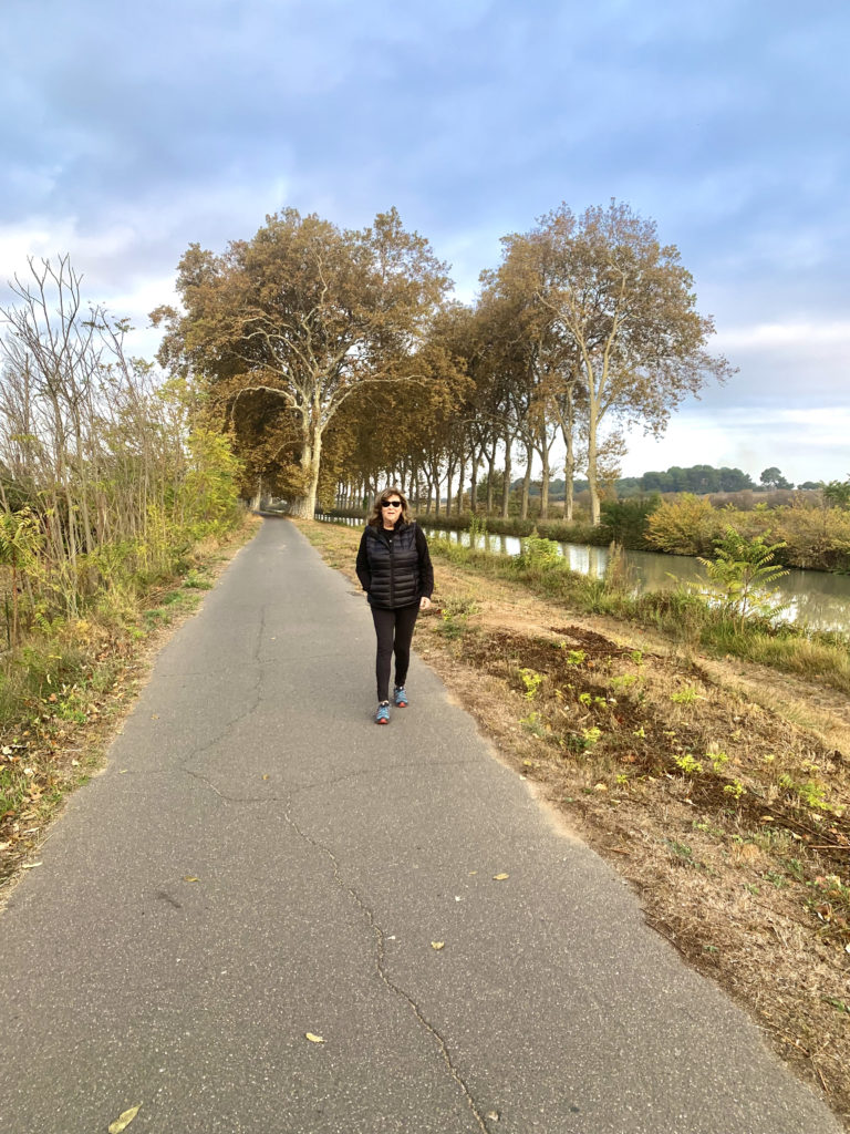 Judi walking on tow path along side Anjodi on canal du midi