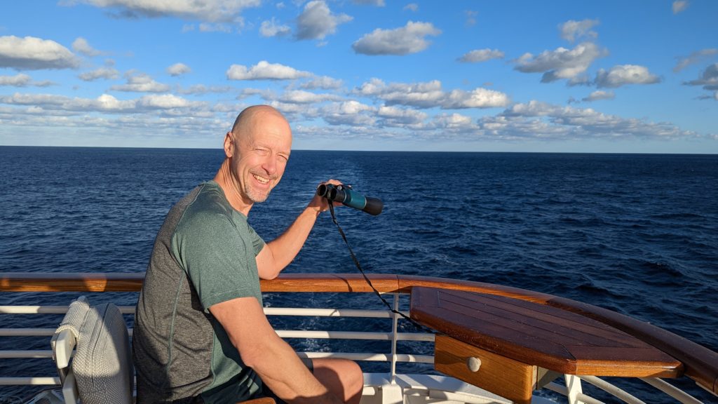 John on deck with binoculars