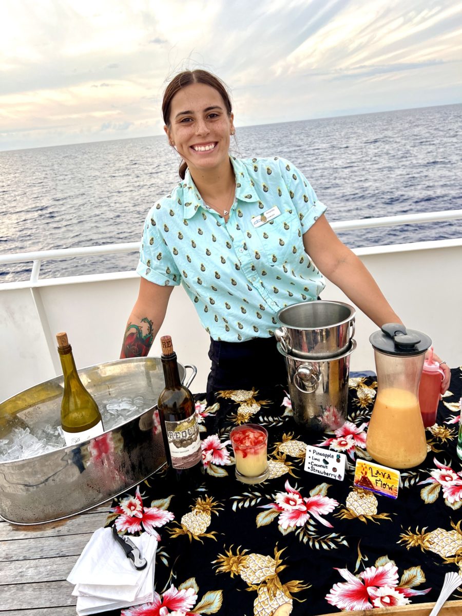 Amanda serving Lava Flows drinks on the top deck of a small-ship Hawaii cruise with UnCruise