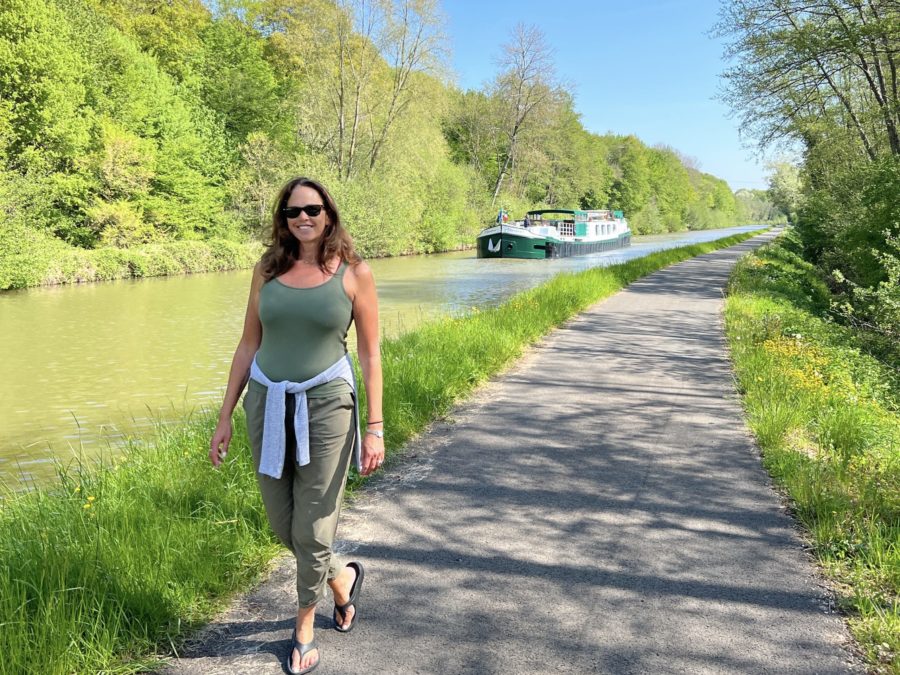 Dana walking next to the canal with Barge Meanderer