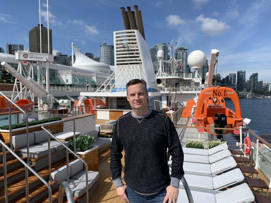 American Queen Voyages' Mike Hicks on the top deck with Ocean Victory alongside at Vancouver's Canada Place