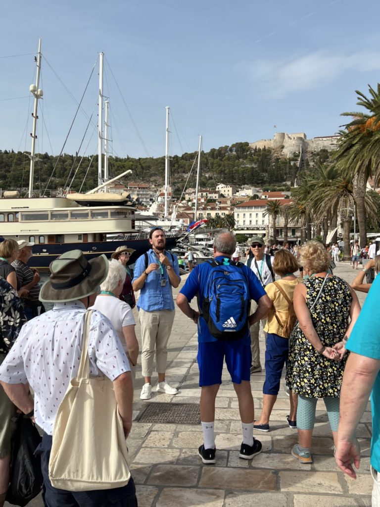 Guide Stan lectures in Hvar Harbor on a Croatian Coastal Cruise