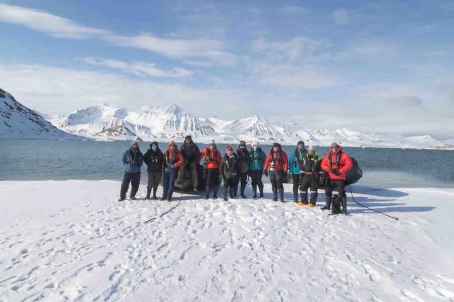 Group photo of all guests and guides on a Zodiac landing in Svalbard