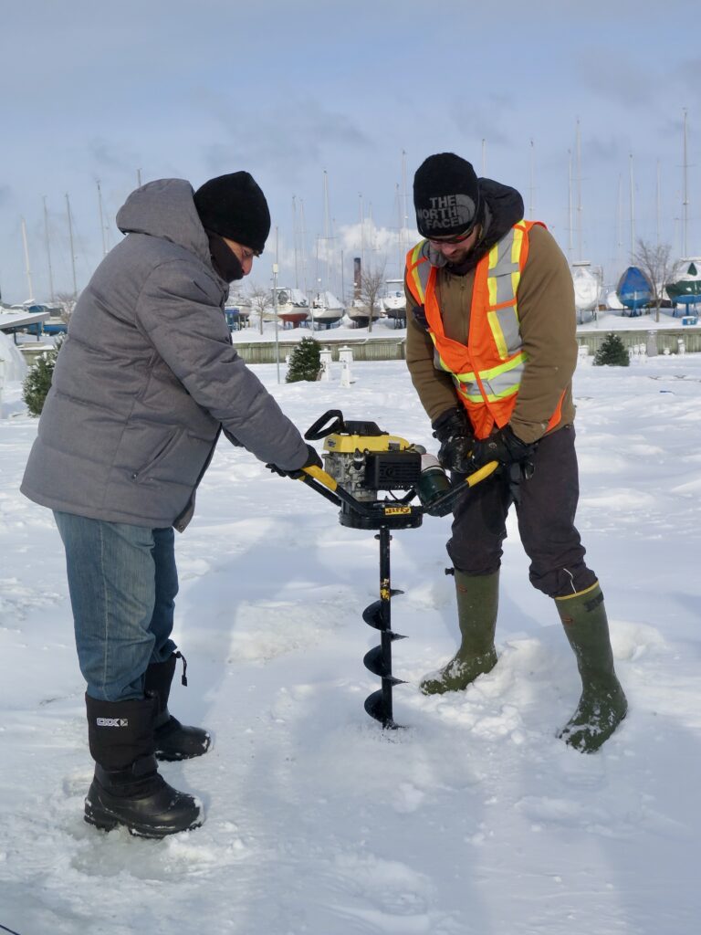 Ice fishing while winter cruising in Canada