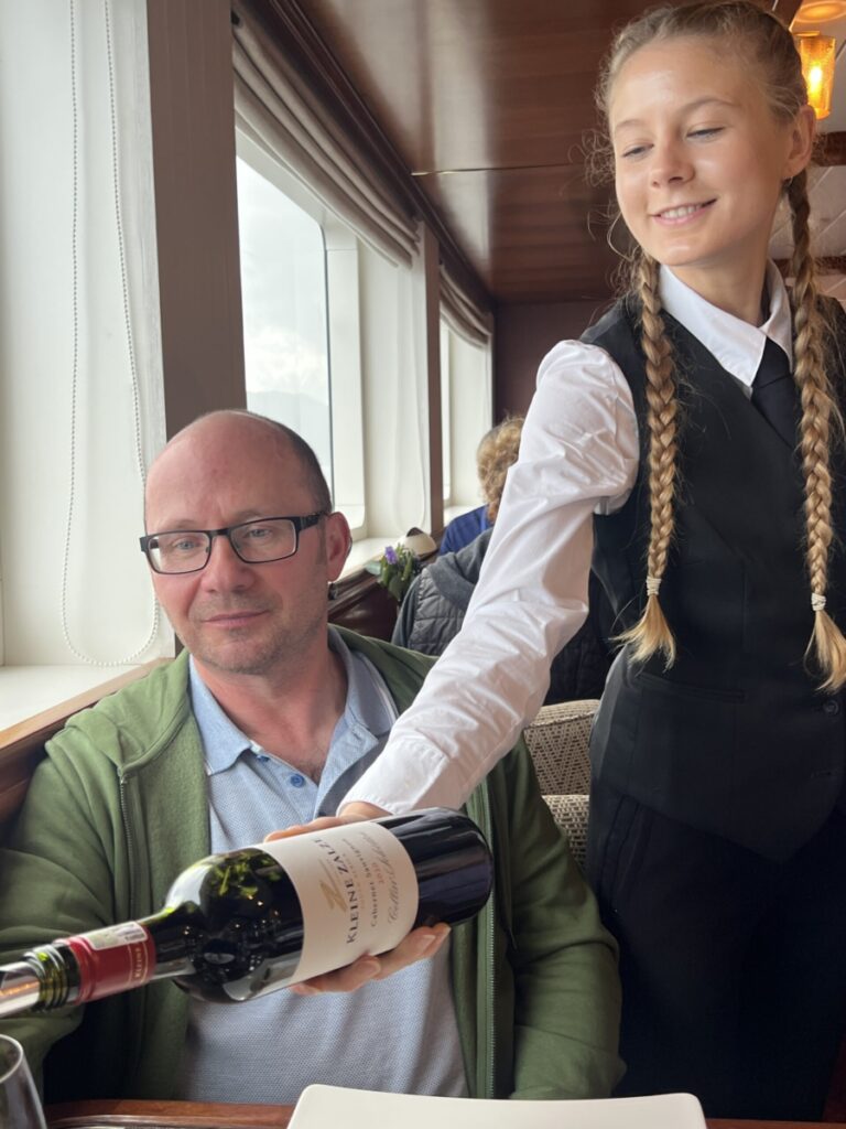 Alissa serving wine aboard a Lord of the Highlands cruise