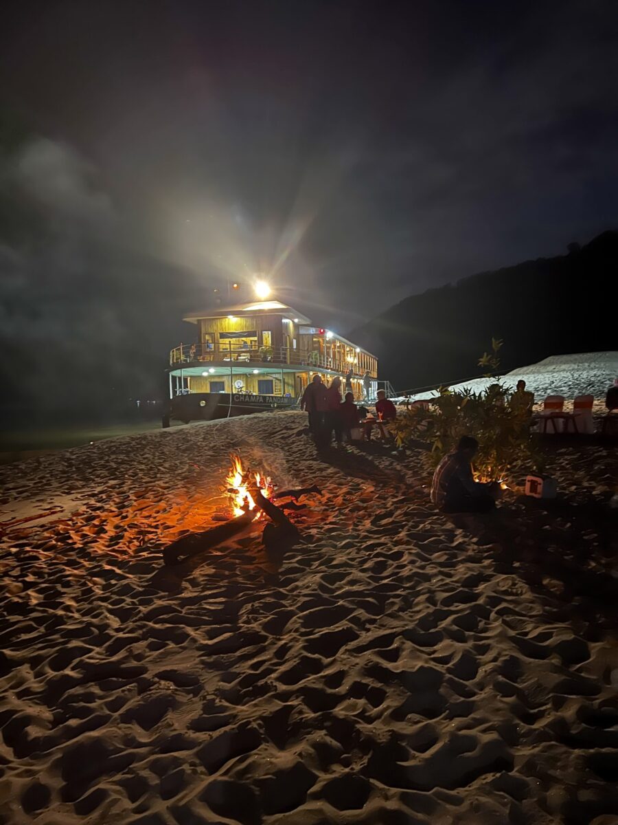 beach party with Champa Pandaw docked on a sand bank