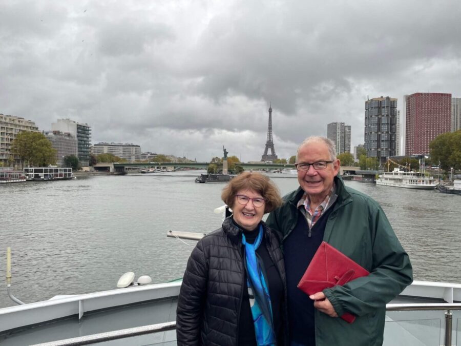John and Sandra Nowlan on Tauck’s Sapphire as the riverboat approaches the Paris Statue of Liberty and the Eiffel Tower