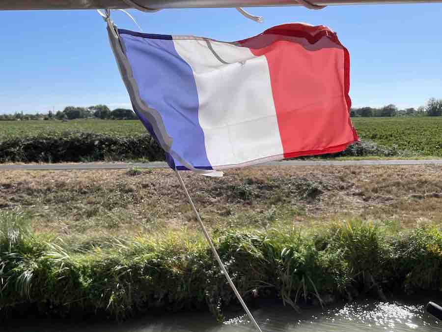  French tri-color billows over the canal.