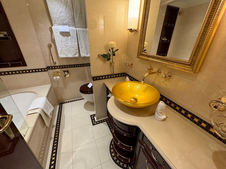 The bathroom of a Category B Sea Cloud Spirit junior suite, with gold-plated sin