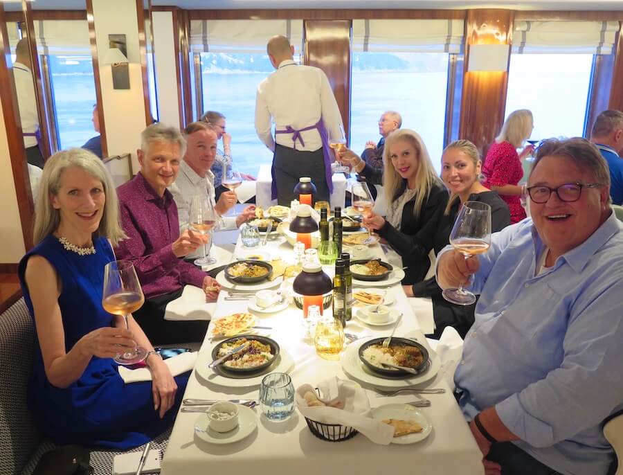 Anne, at left, dining with World Traveller gastronomic guests Rudi and Jennifer Scholdis, right and center right, tasting wine purchased from an excursion to Bandol.