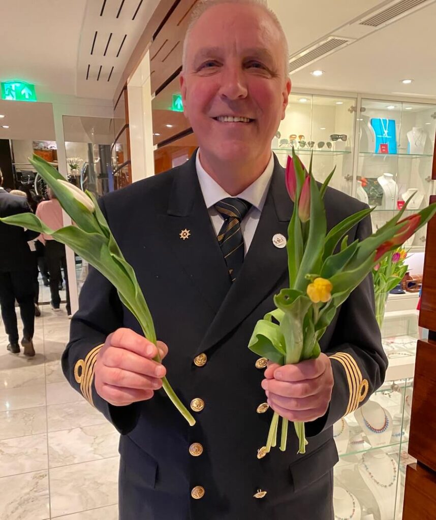 Captain Eddy Poppema handing tulips on a Tulip Time cruise