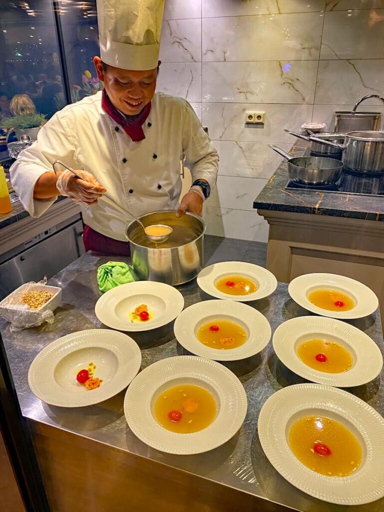 Chef I Putu Krisna preparing a dish for The Chef's Table on a Tulip Time cruise