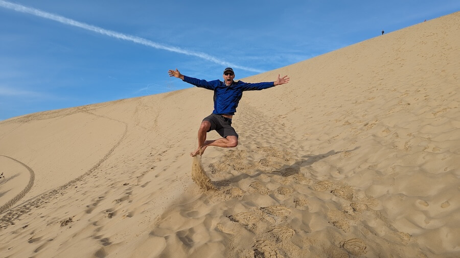 John having fun at the Dune du Pilat, the tallest sand dune in Europe on his biking river cruise