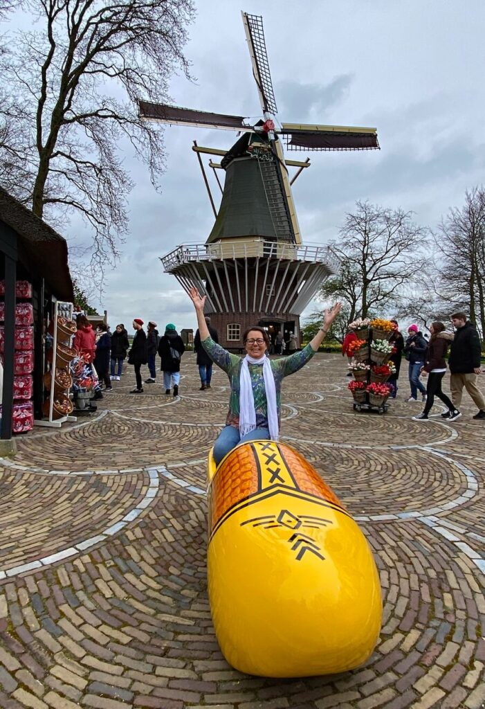 writer Katherine Rodeghier with windmill and wooden shoe at Keukenhof