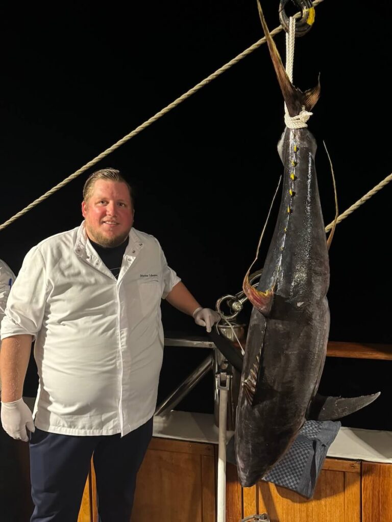 Sea Cloud II’s chef is dwarfed by the catch of the day