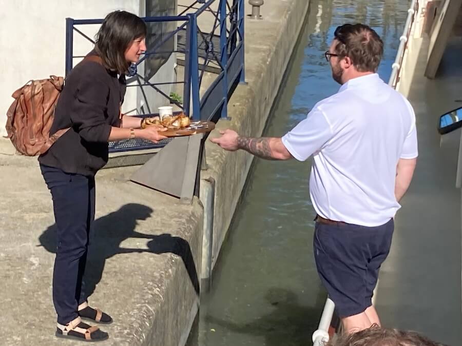 Crew from the Roi Soleil Barge Cruise feeding the lock keepers