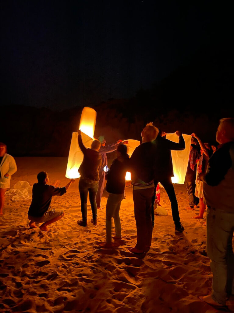 Releasing lanterns into the night sky on a Mekong Sun cruise