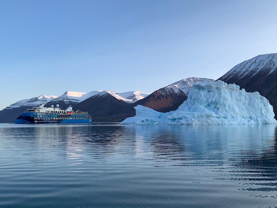 Ocean Albatros with iceberg and snow-dusted mountains (Photo - Anne Kalosh)