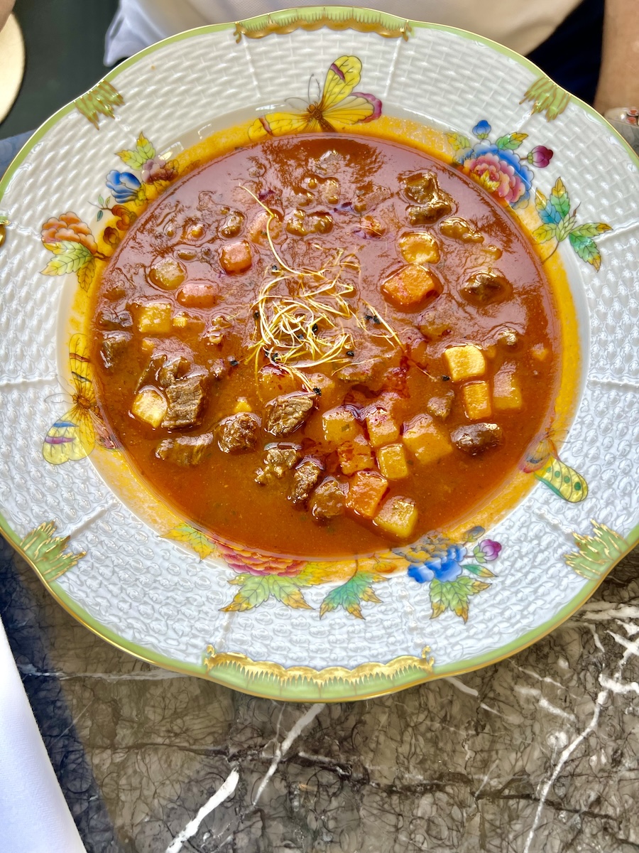 Hungarian goulash soup served in Herend porcelain bowl