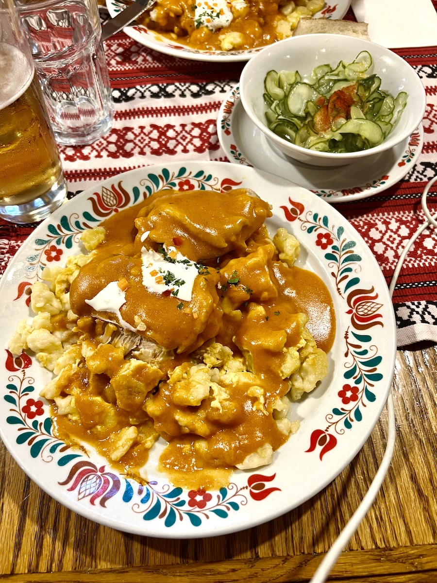 Chicken paprikas and cucumber salad in Hungary