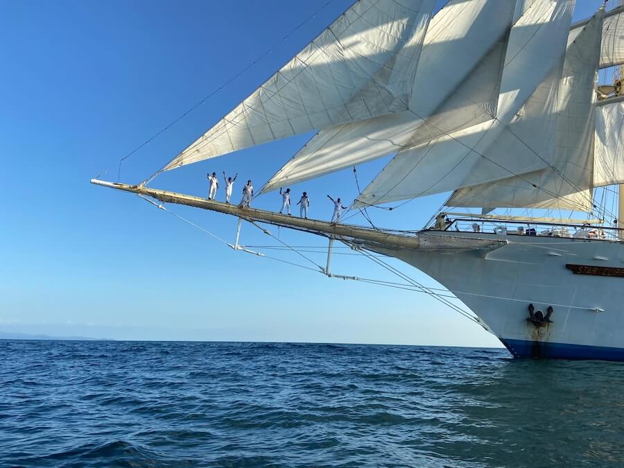 The crew filing on to the bow sprit and mugging it up for passengers on the photo safari