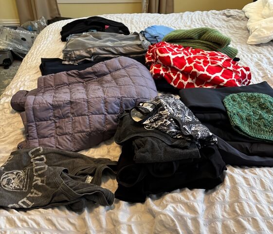 Author's growing packing pile led her to wonder if ChatGPT Make a Good Packing List?