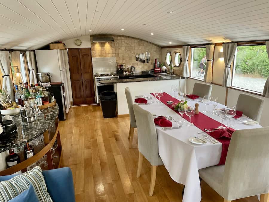 The dining area with open kitchen aboard Enchante on a Canal du Midi Barge Cruise