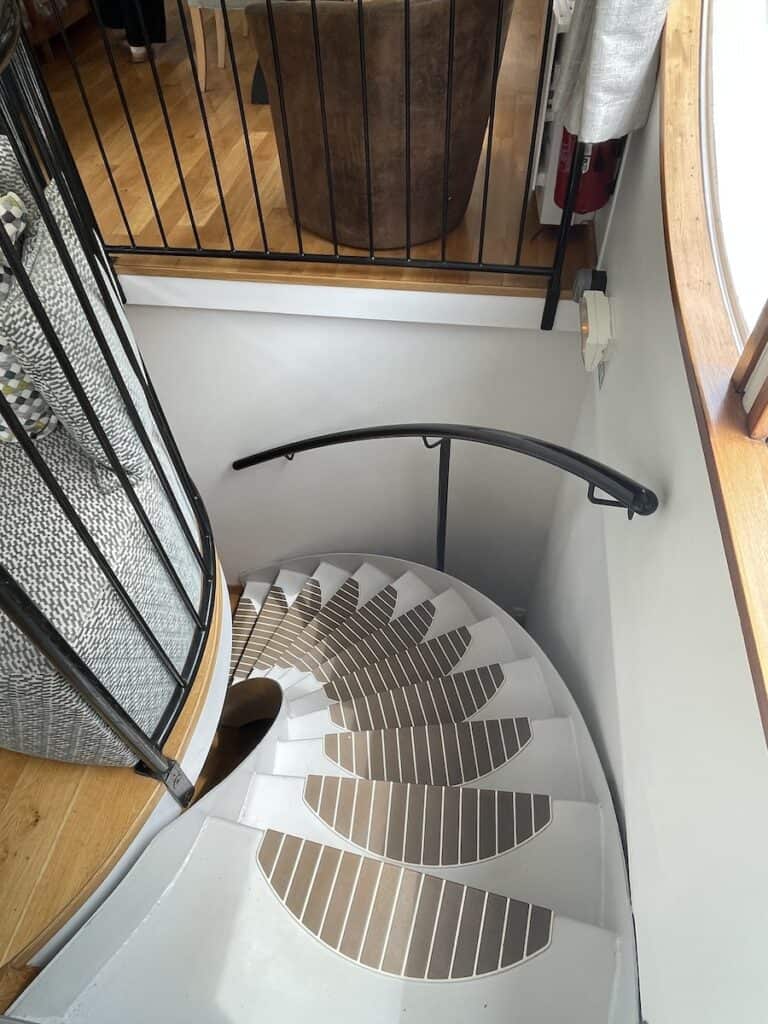 The curved stairway to the cabins aboard Enchante barge