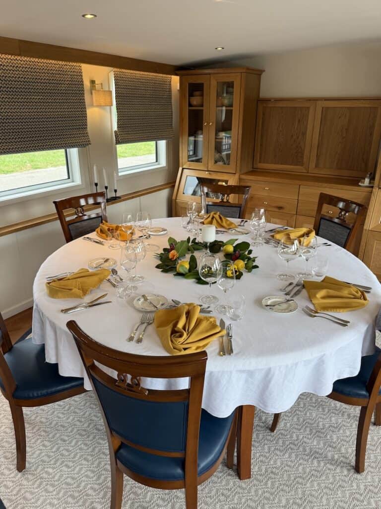 The table is set for dinner aboard the Kir Royale on a Marne Canal cruise
