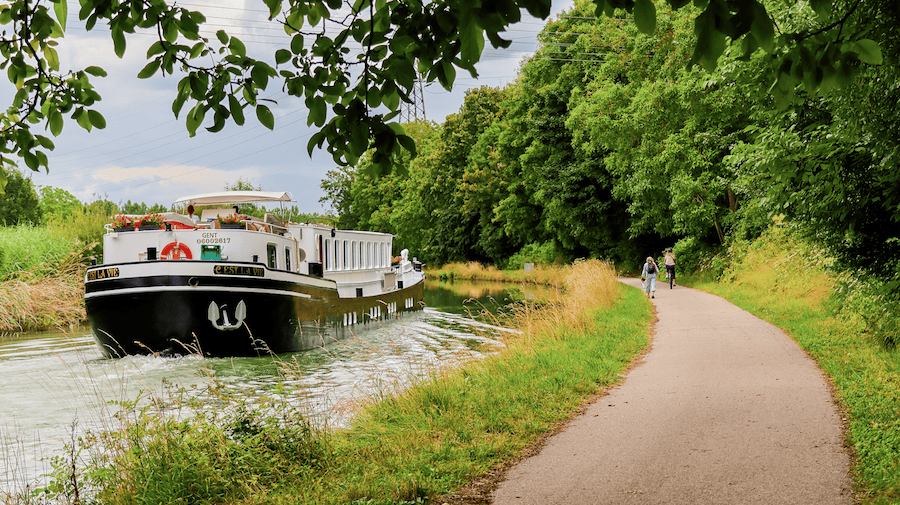 Cycling alongside the C’est La Vie on the towpath