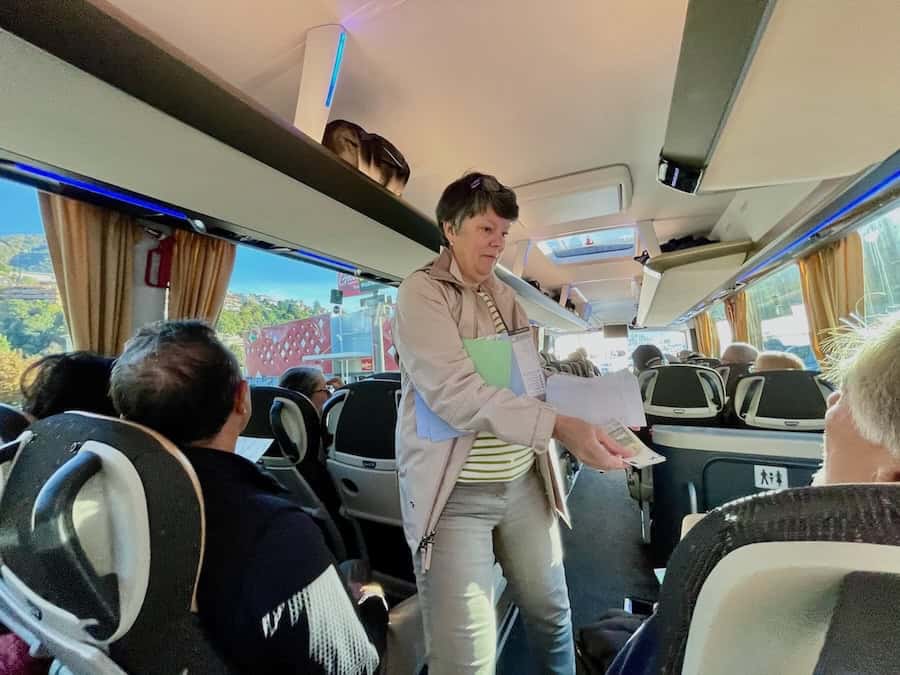 A Tauck Tour Director gives each guest 5 Euros for a café bathroom break