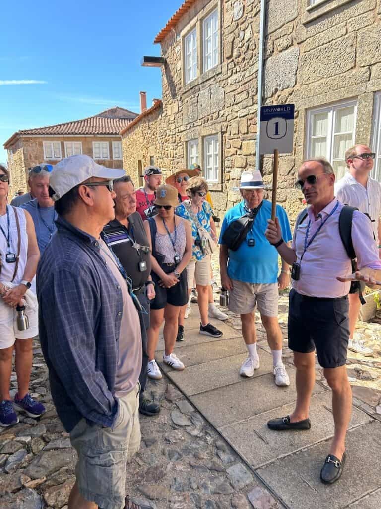 Douro River Cruise Review (2026): Why Uniworld Does Everything Right 9 Cruise Manger Ricardo was excellent, here leading a tour at the Castelo Rodrigo.commentary on the crew and service