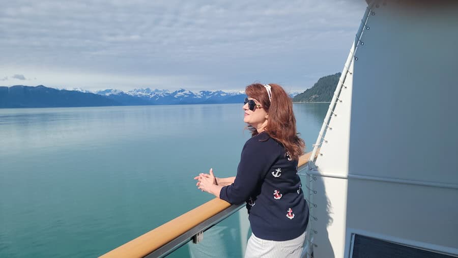 The author enjoying the Alaskan scenery from her balcony on the American Constitution