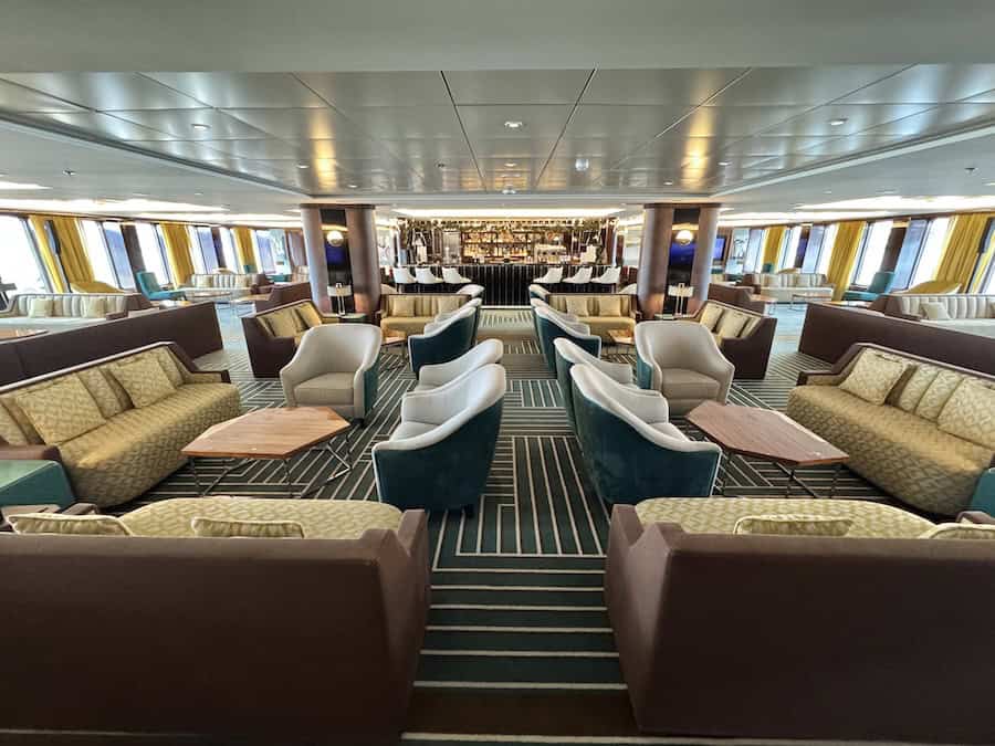 Atlas Antarctica Cruise Review (2026): At Last, On A Real Expedition Ship, the World Navigator 9 Art Deco-inspired Atlas Lounge is covered in the Atlas Antarctica Cruise Review