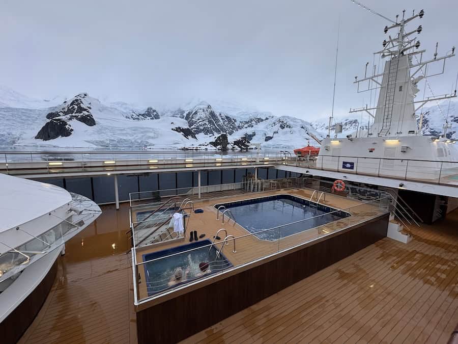 Atlas Antarctica Cruise Review (2026): At Last, On A Real Expedition Ship, the World Navigator 22 Atlas Antarctica Cruise Review shares info about camping on shore and also soaking in the hot tub