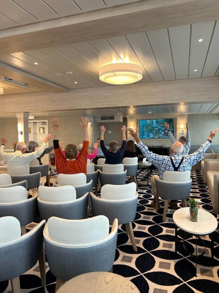 Guided stretch class in the Chesapeake Lounge on a Chesapeake Bay Cruise With American Cruise Lines