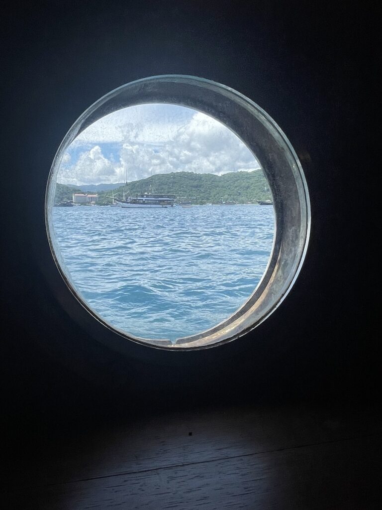 A porthole aboard the Ombak Putih on a SeaTrek Indonesia Sailing Cruise