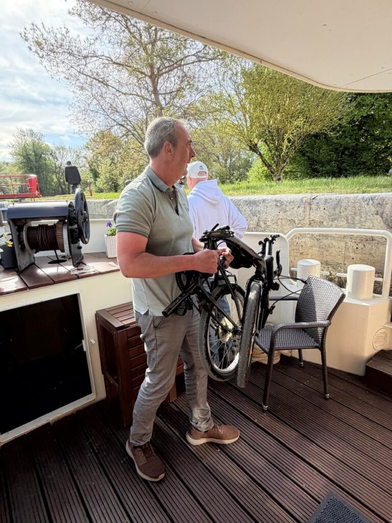 This French Barge Is Different (2026 REVIEW) — Choose The Savoir Vivre On The Burgundy Canal For The Cycling & Dinners Ashore 3 foldable bicycles being put together along side the Savoir Vivre