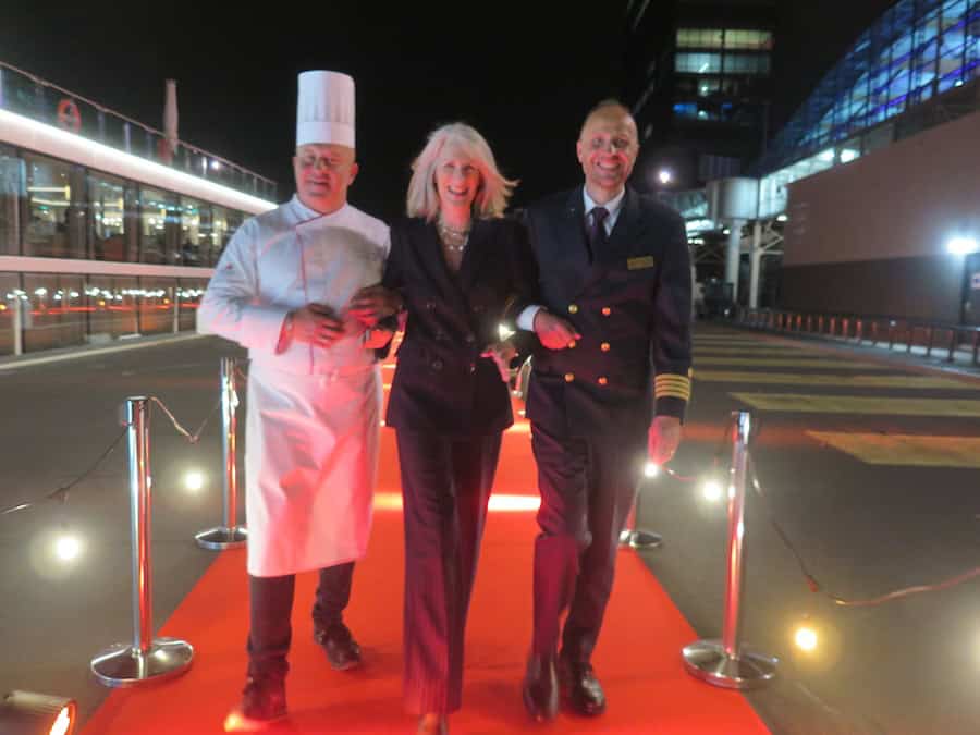 7 New Viking River Vessels Inaugurated In Amsterdam Last Week (OCT 2026) 11 7 New Viking River Vessels Inaugurated and author Anne Kalosh poses with the captain and chef on the red carpet
